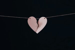 Picture of a broken heart hanging on a string